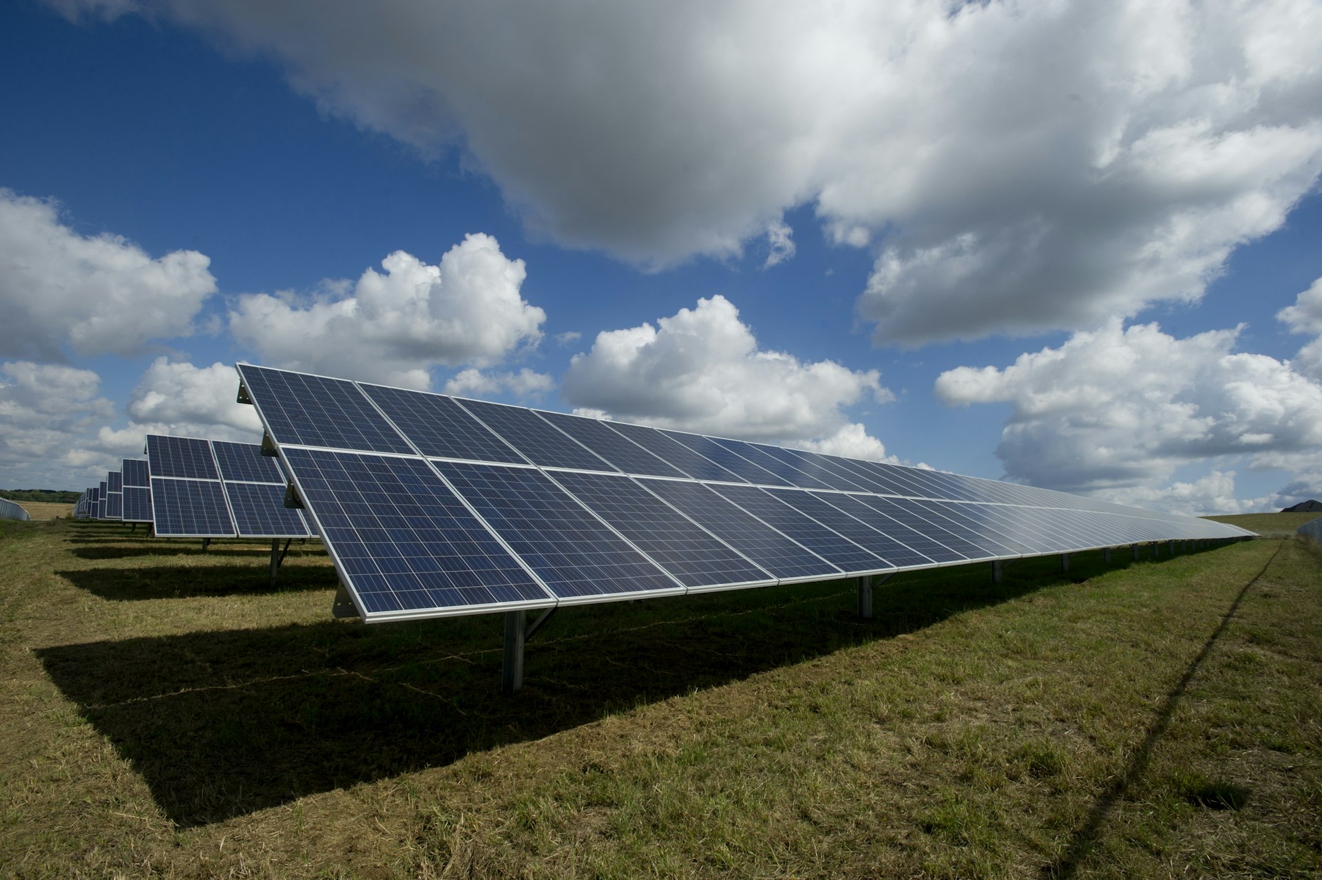 Panoramic view of solar panels and green mountains on a clear day in Spain